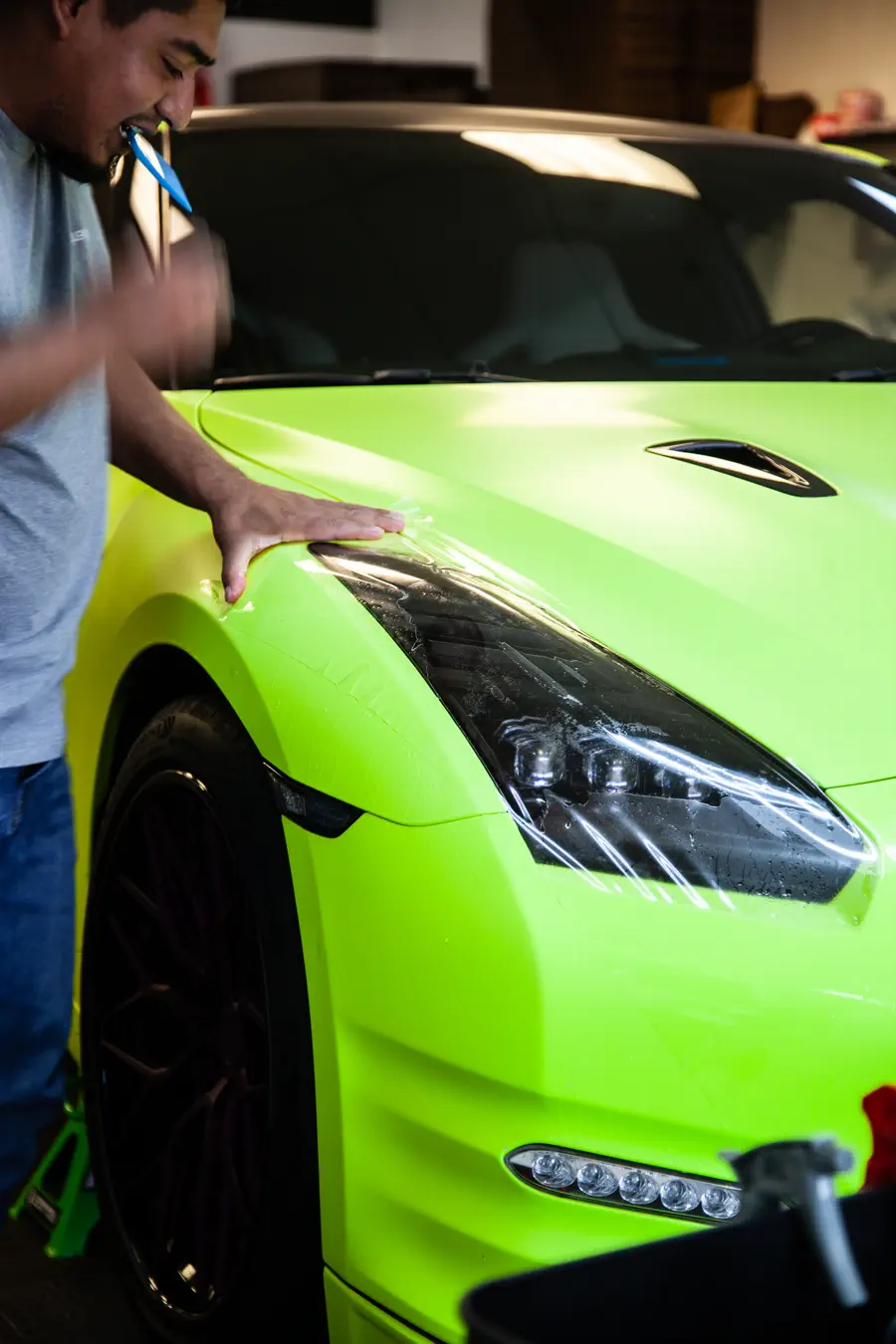 Clear protection film being fitted to a lime green Nissan GT-R at FRQNCY