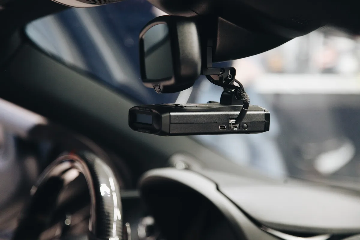 Radar detector hard-wired behind the mirror of a McLaren at FRQNCY
